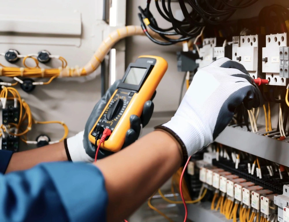 An engineer taking readings from an electrical installation.