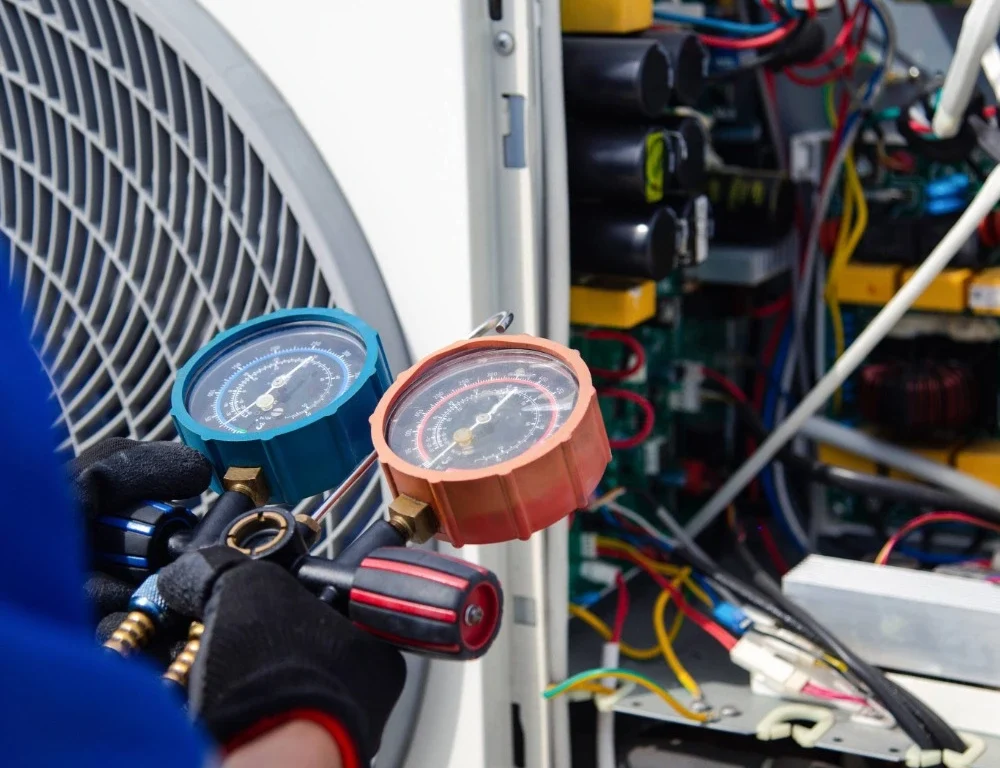 An engineer taking a reading for an external HVAC system.