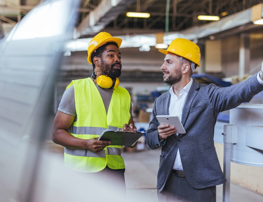 An engineer and facilities manager converse.