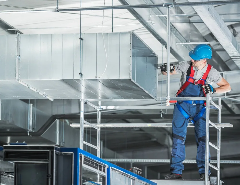 An engineer inspecting the inside of a duct.