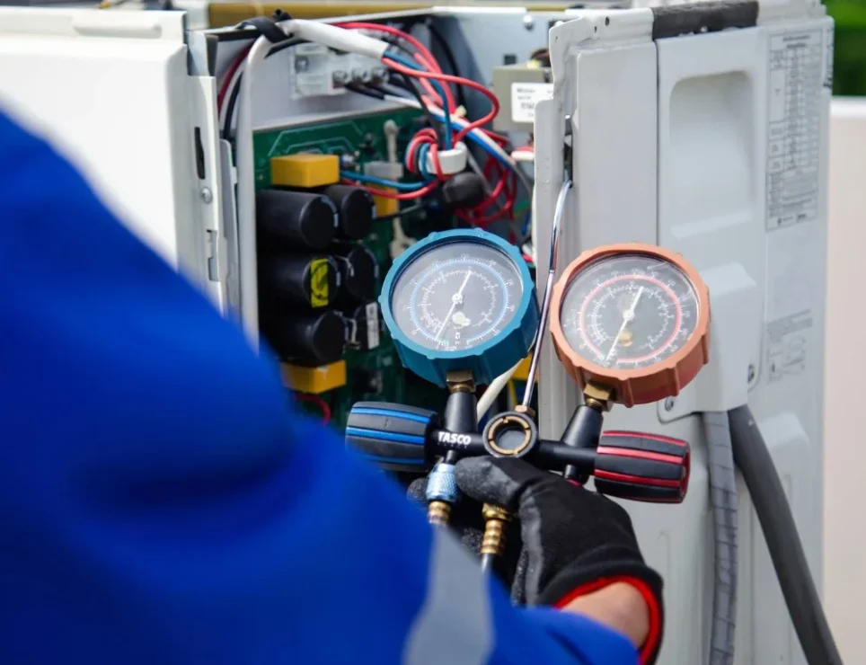 An engineer taking a reading from an HVAC system.