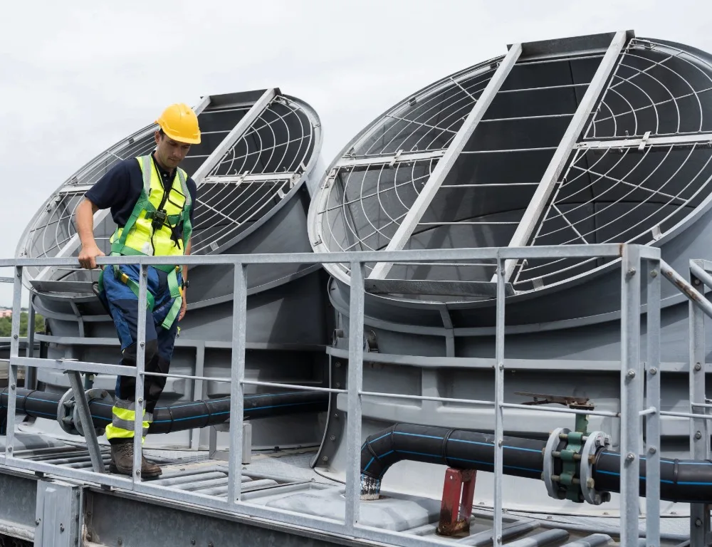 An engineer on the roof of a commercial facility carrying out an inspection.