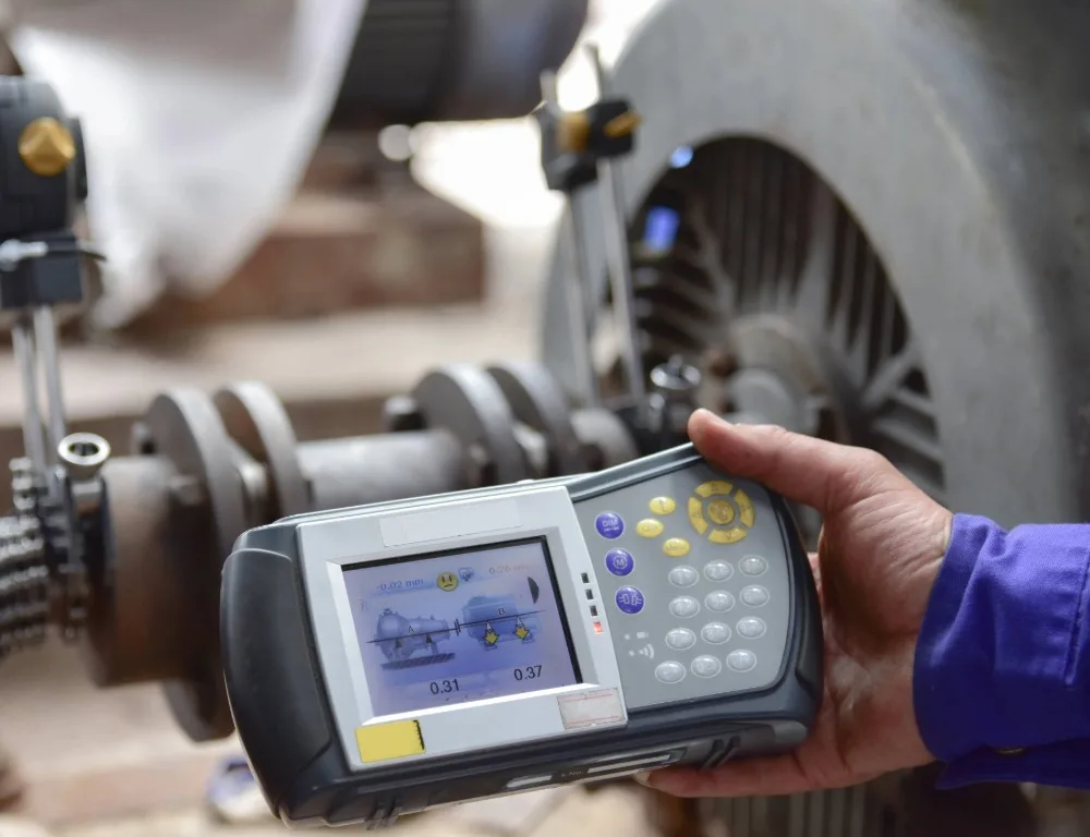 An engineer using specialist equipment to carry out motor shaft alignment.